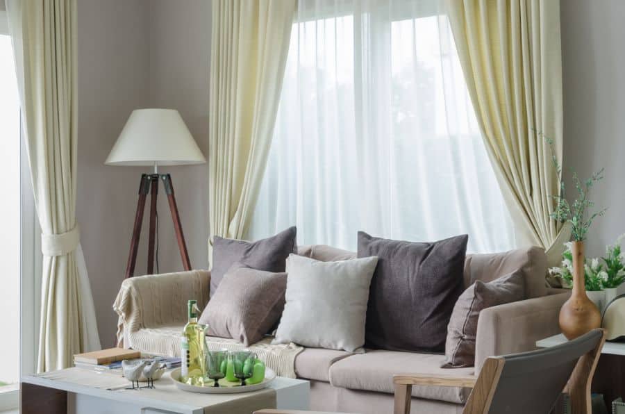 neutral green curtains, gray sofa in the living room 