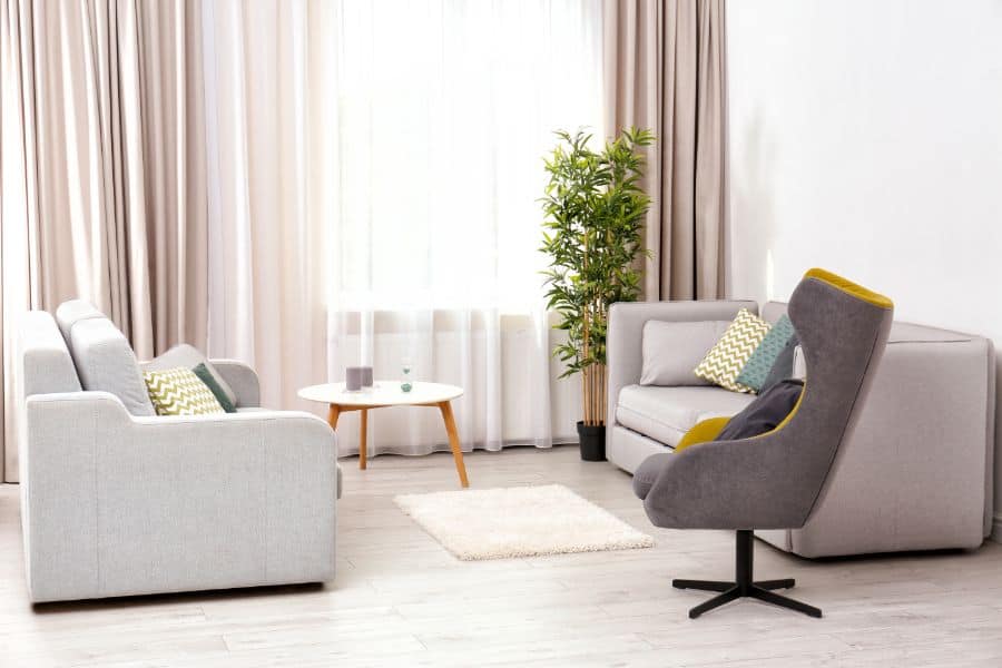 neutral curtains in muted colors with sofa and accent chair 