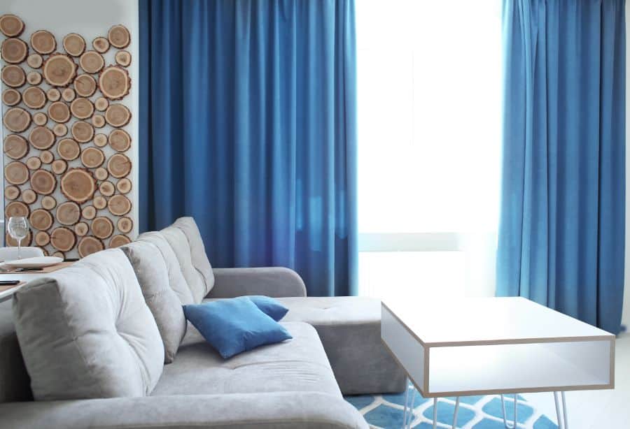 blue curtains and gray sofa in the living room 