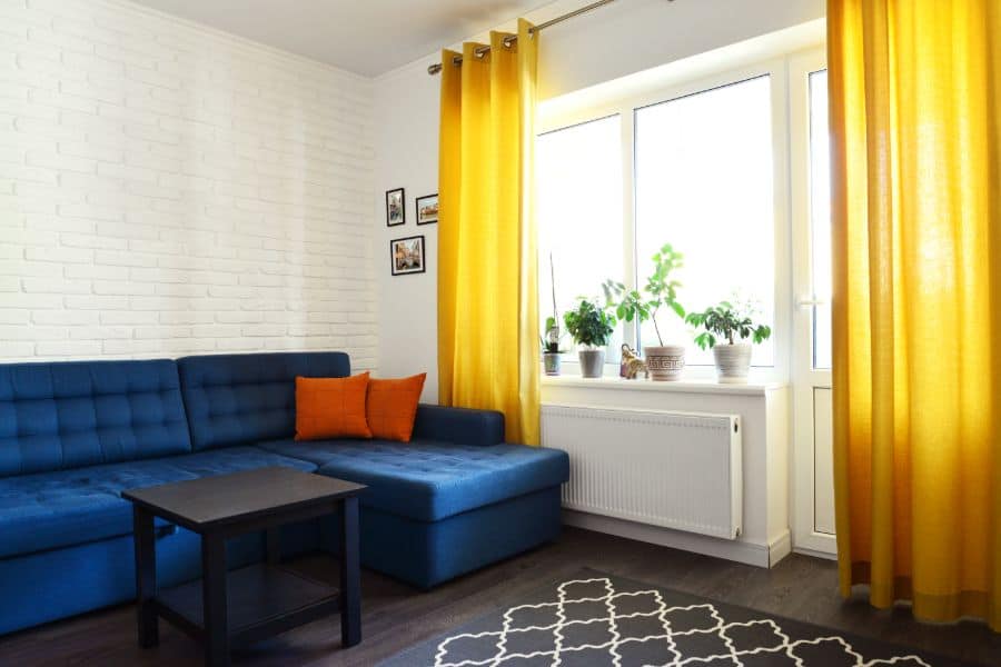 Yellow curtains and blue sofa in the living room 