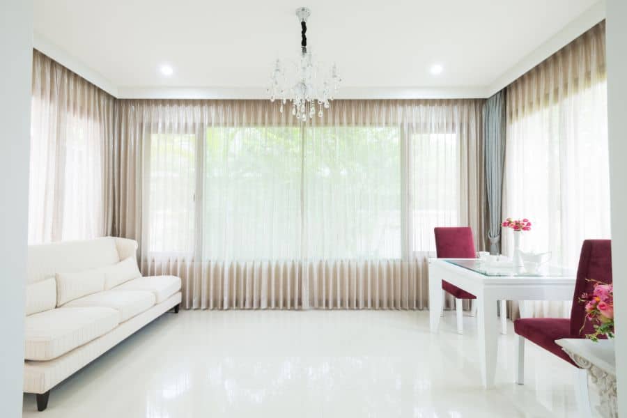 large spacious white room with chandelier