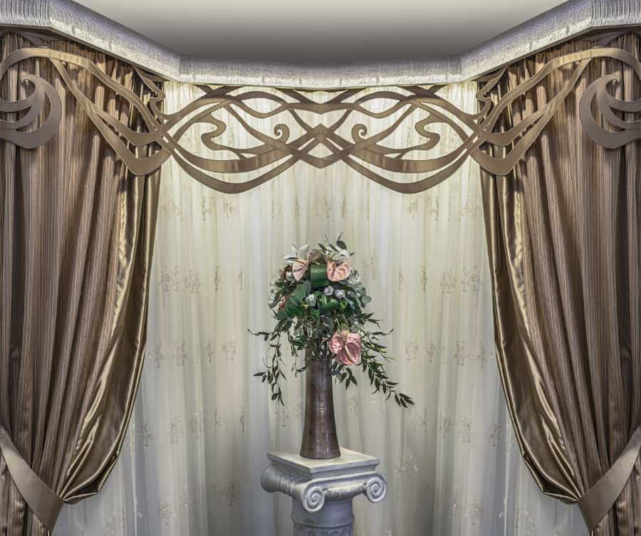 Valance curtains with floral arrangement in the middle 