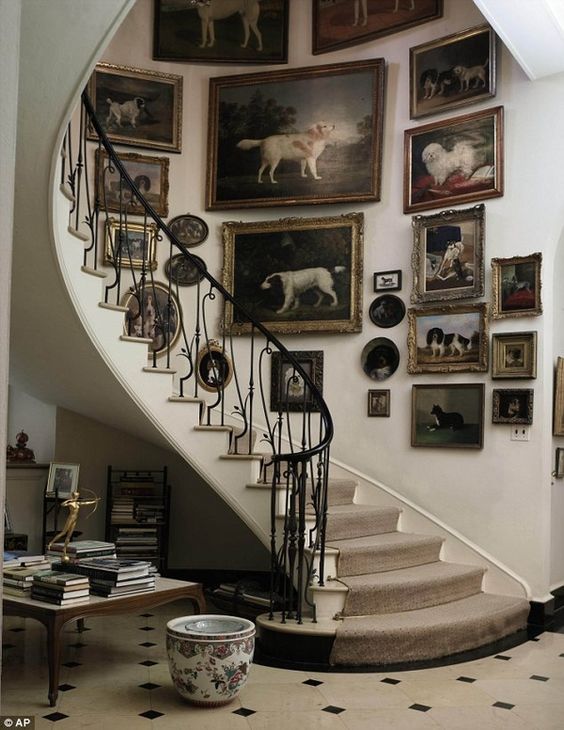 A beautiful vintage-style gallery wall with artwork dedicated to dogs and vintage frames is a great idea