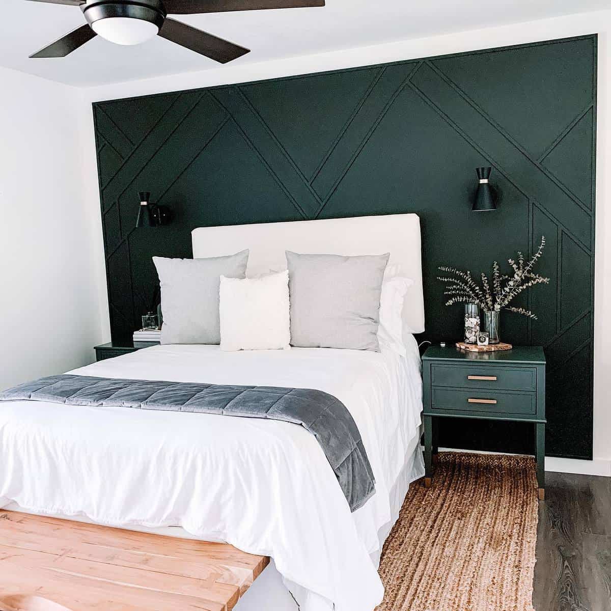 Green accent wall, bedroom, green bedside table, sconces, lights, wooden bench 