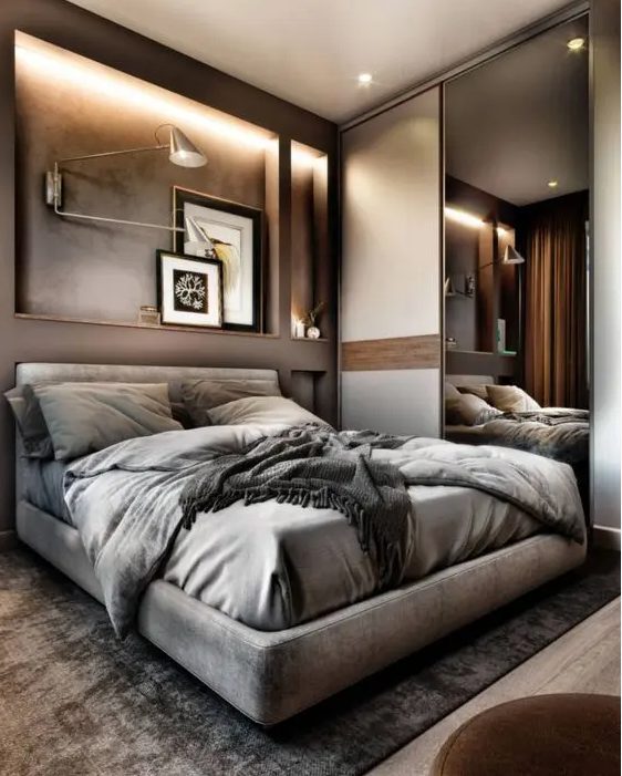 a beautiful taupe bedroom with illuminated alcoves, a floating upholstered bed, gray linens, lamps and storage with a sliding mirror door
