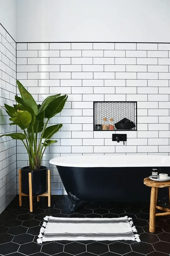 a chic bathroom with a black retro freestanding bathtub that fits the space perfectly