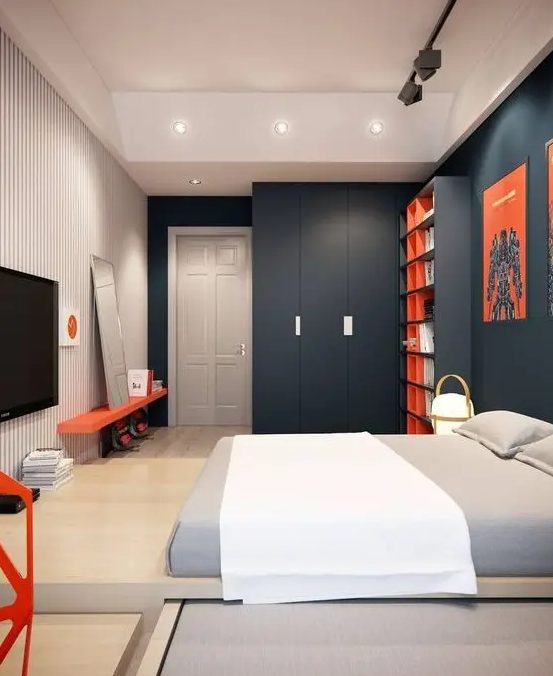 A clean, minimalist or modern teen room with charcoal gray walls, a striped bedroom, a platform bed and bright red accents