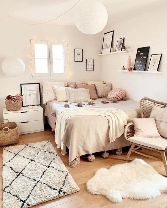 A cozy Scandinavian teen room with a bed with neutral and pastel linens, a bedside table, a rattan chair, a gallery wall and pastel pillows