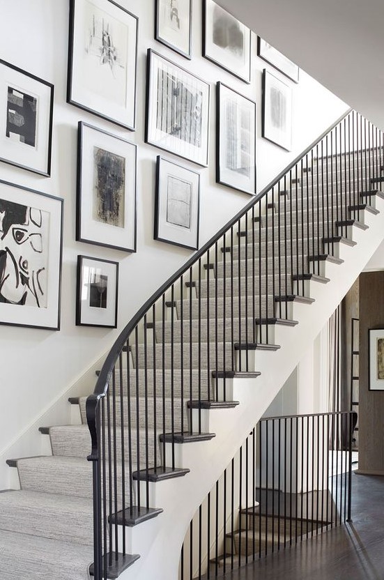 A freeform gallery wall with black frames and black and white artwork adds elegance and chic to the room and makes it artistic
