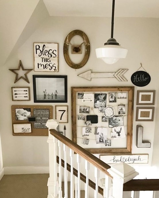 A large rustic gallery wall with framed family pictures, a memo board with photos and monograms, arrows and letters is cool