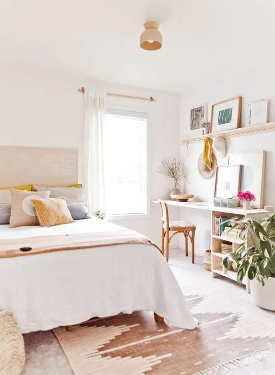 a beautiful, light-filled teenager's room with a bed, a small desk with storage space, a mantel with artwork and potted plants