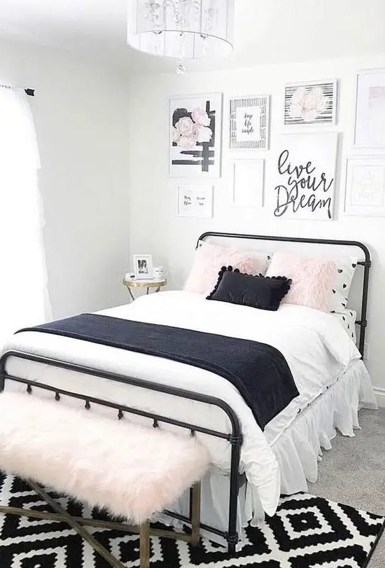 A pretty teenager's bedroom with a black metal bed, contrasting bedding, a pretty gallery wall and a pink faux fur bench