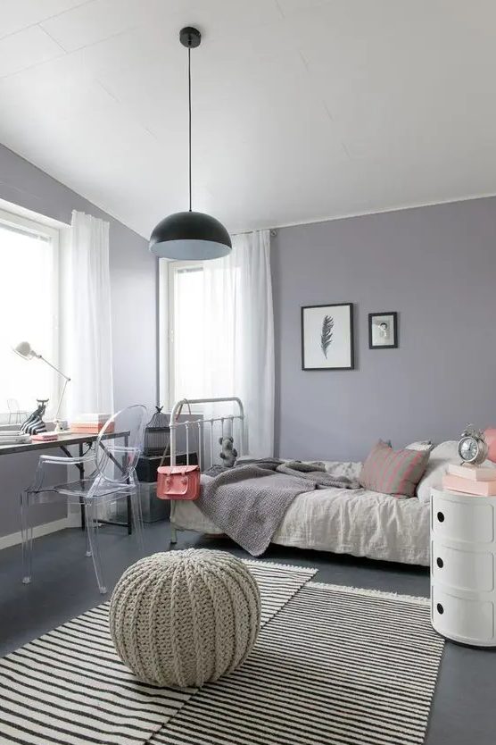 A modern gray and purple teenage girl's bedroom with eclectic furniture, neutral textiles and a pendant lamp