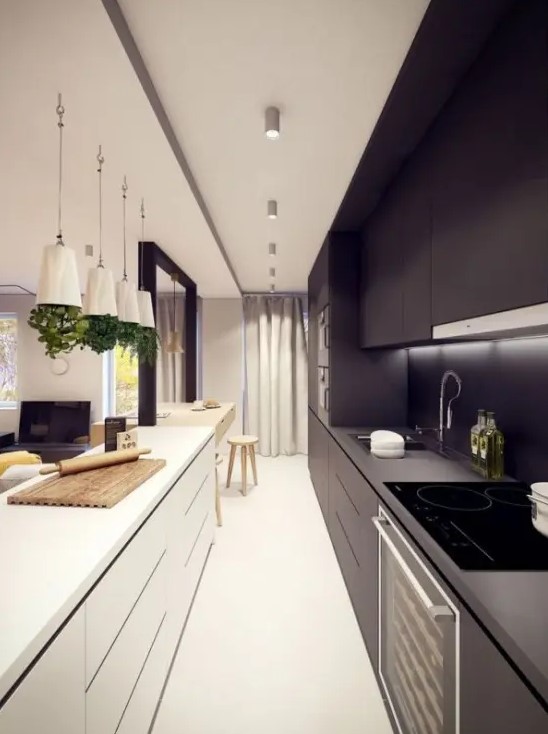 a narrow black and white kitchen with elegant cabinets, recessed lighting and pendant lamps, and herb pots