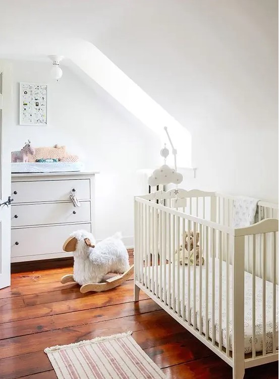 a neutral attic children's room with simple and casual furniture, muted and printed textiles and lots of cute toys
