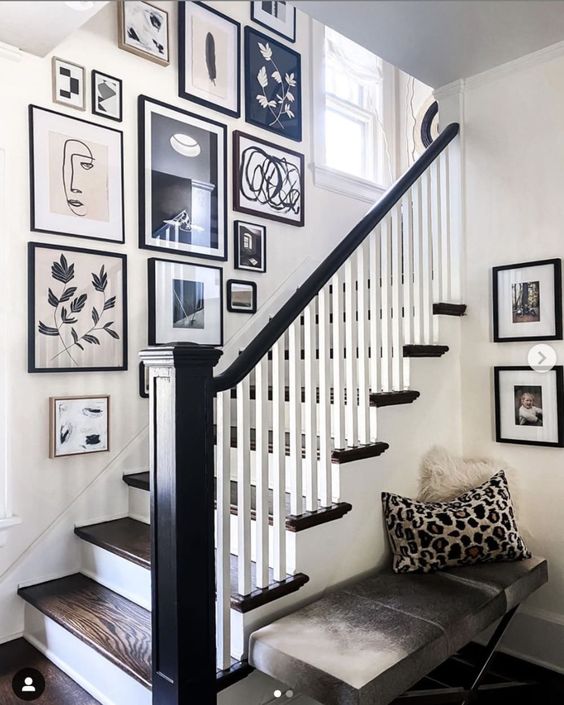 A stylish and cool black and white gallery wall with eye-catching graphic artwork is a beautiful idea for a high-contrast room