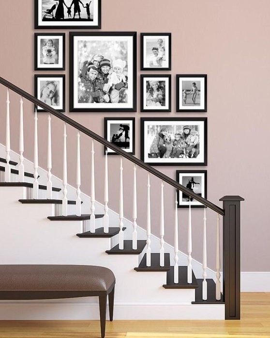 A stylish, free-form gallery wall with black and white family pictures and black frames adds a sophisticated touch to the room