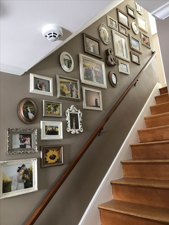 A vintage gallery wall with mismatched frames, photos, artwork and different types of decor