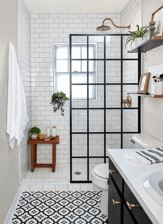 a vintage-inspired bathroom with white and printed subway tiles, a shower area with a divider, a black vanity and shelves