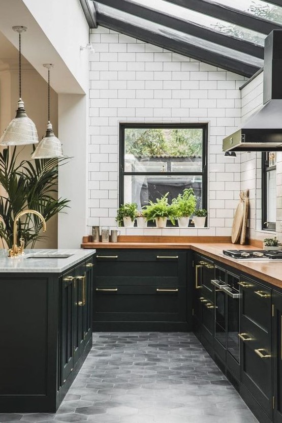 A sleek black Art Deco kitchen with butcher block countertops, white subway tiles and a glazed ceiling