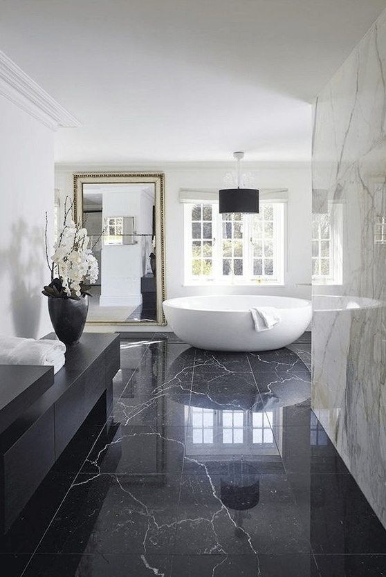 Black marble tiles on the floor add luxury and chic, and white marble tiles on the walls only add to it