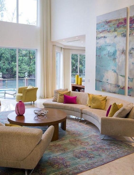 A mid-century modern living room with a curved sofa, colorful pillows and a watercolor artwork for added color