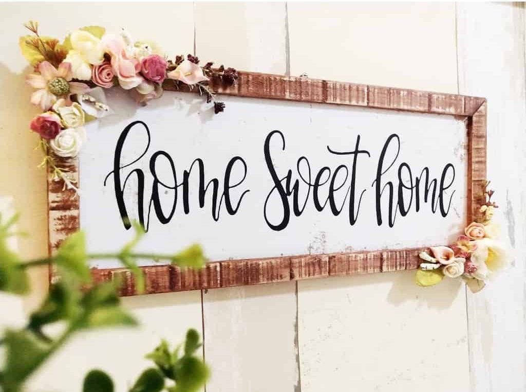 Wooden sign “Home Sweet Home” with flowers 