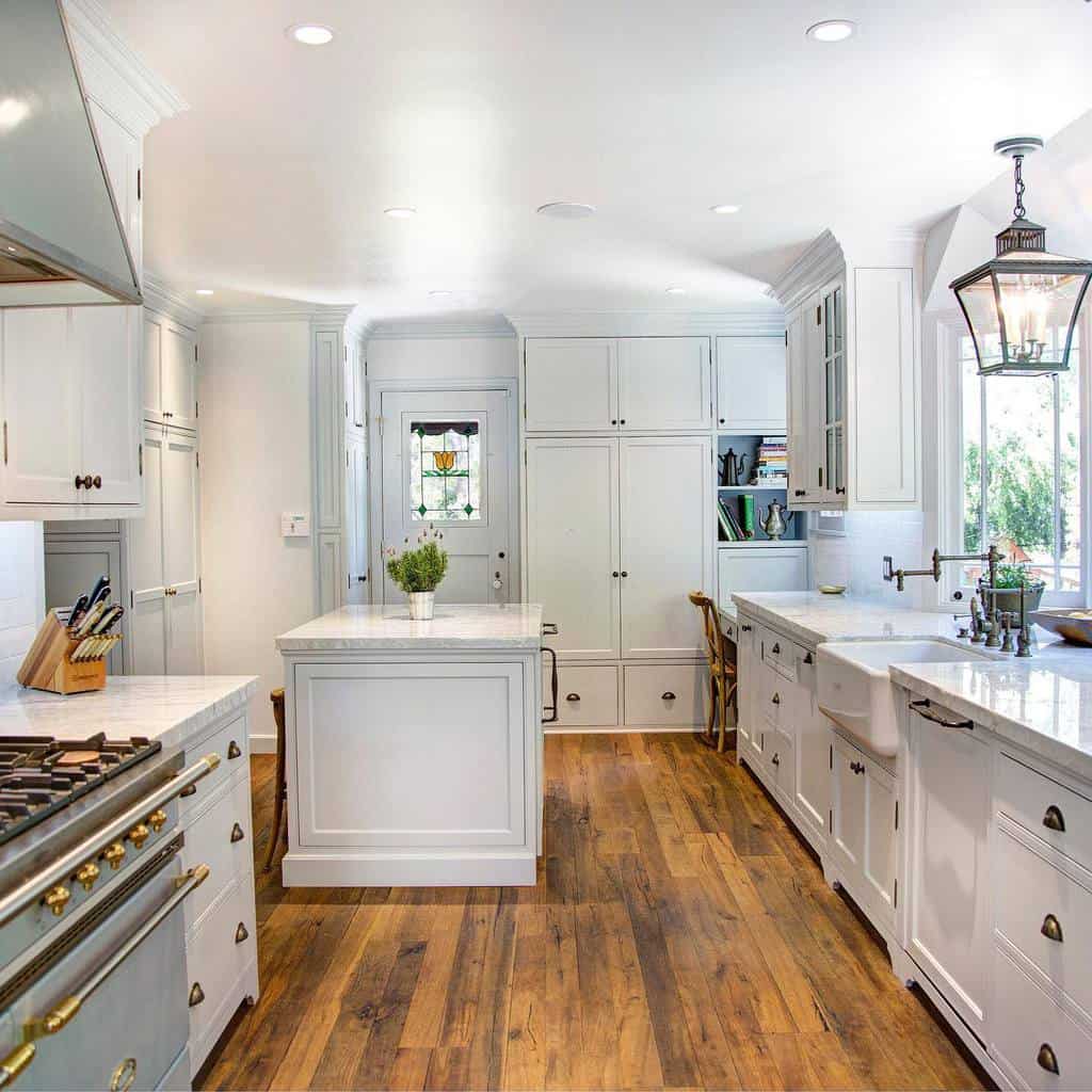 large white kitchen with sink and island 
