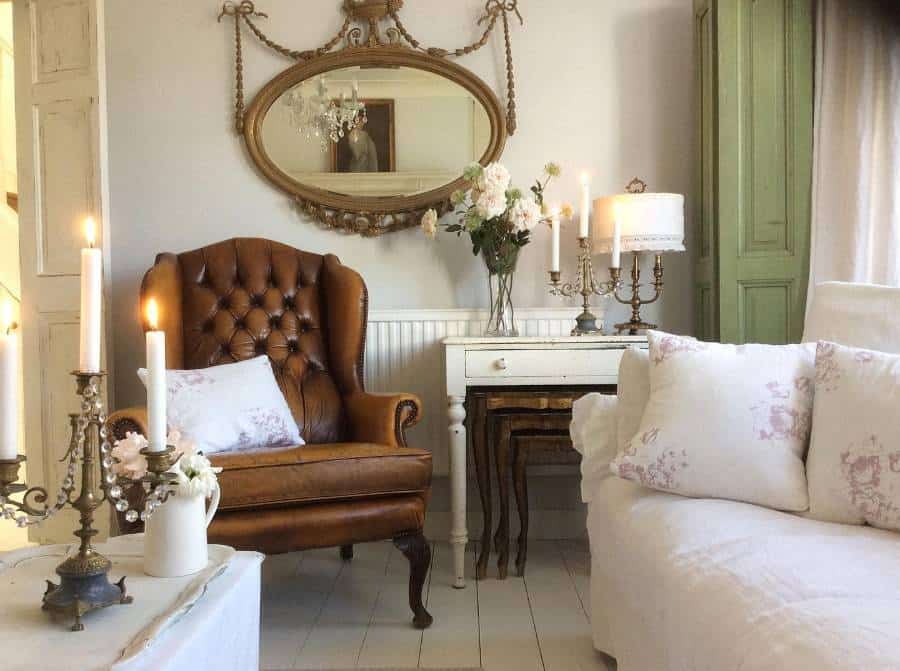French country living room, brown leather, accent chair, candlestick, wall mirror, white sofa