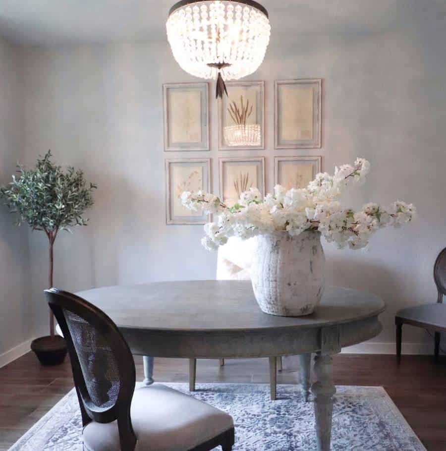 Gray French country dining room round table with flower vase 