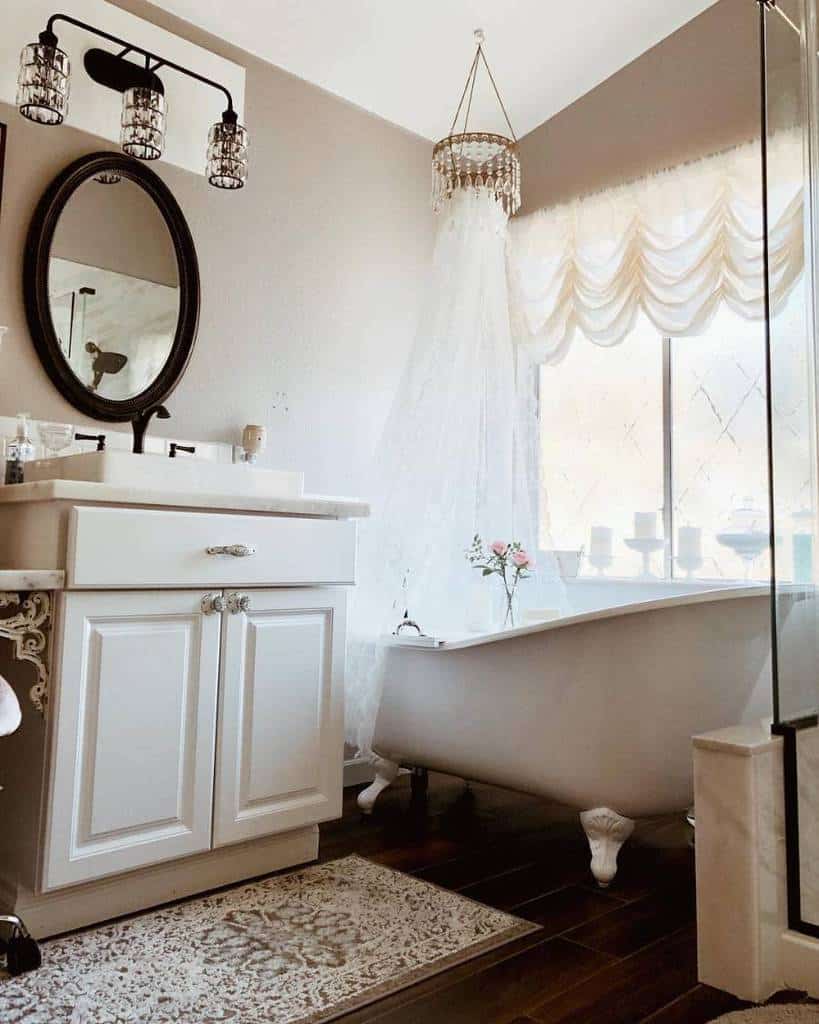 Country style bathroom, white vanity, black accent wall mirror, freestanding bathtub