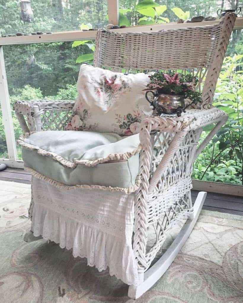 White vintage wicker rocking chair with floral cushions 