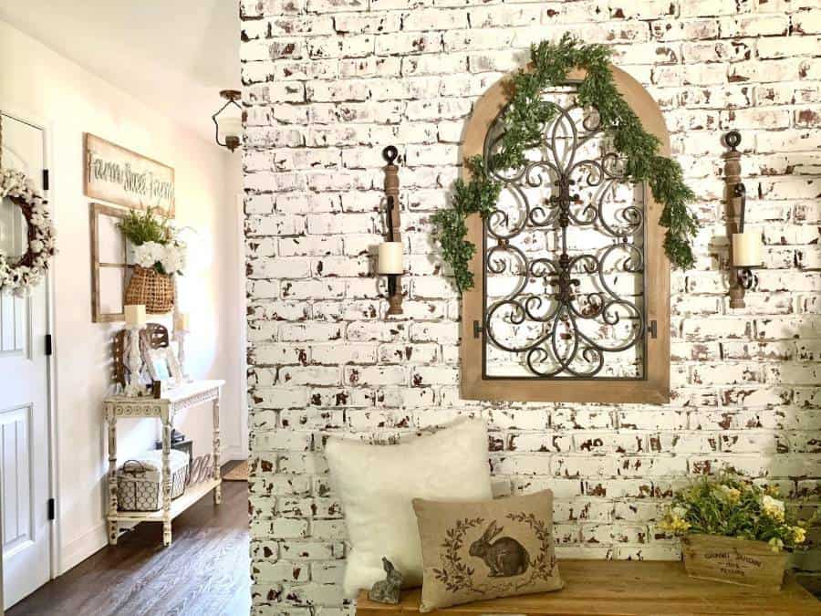 white brick wallpaper, wall candles, wooden bench seat cushions 