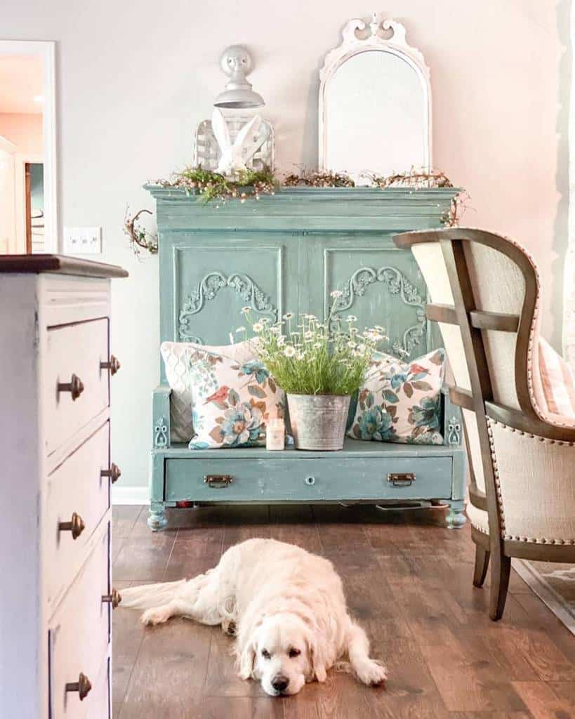 green cupboard, flower cushion, tin pot, plant, white cupboard, wooden floor, dog 