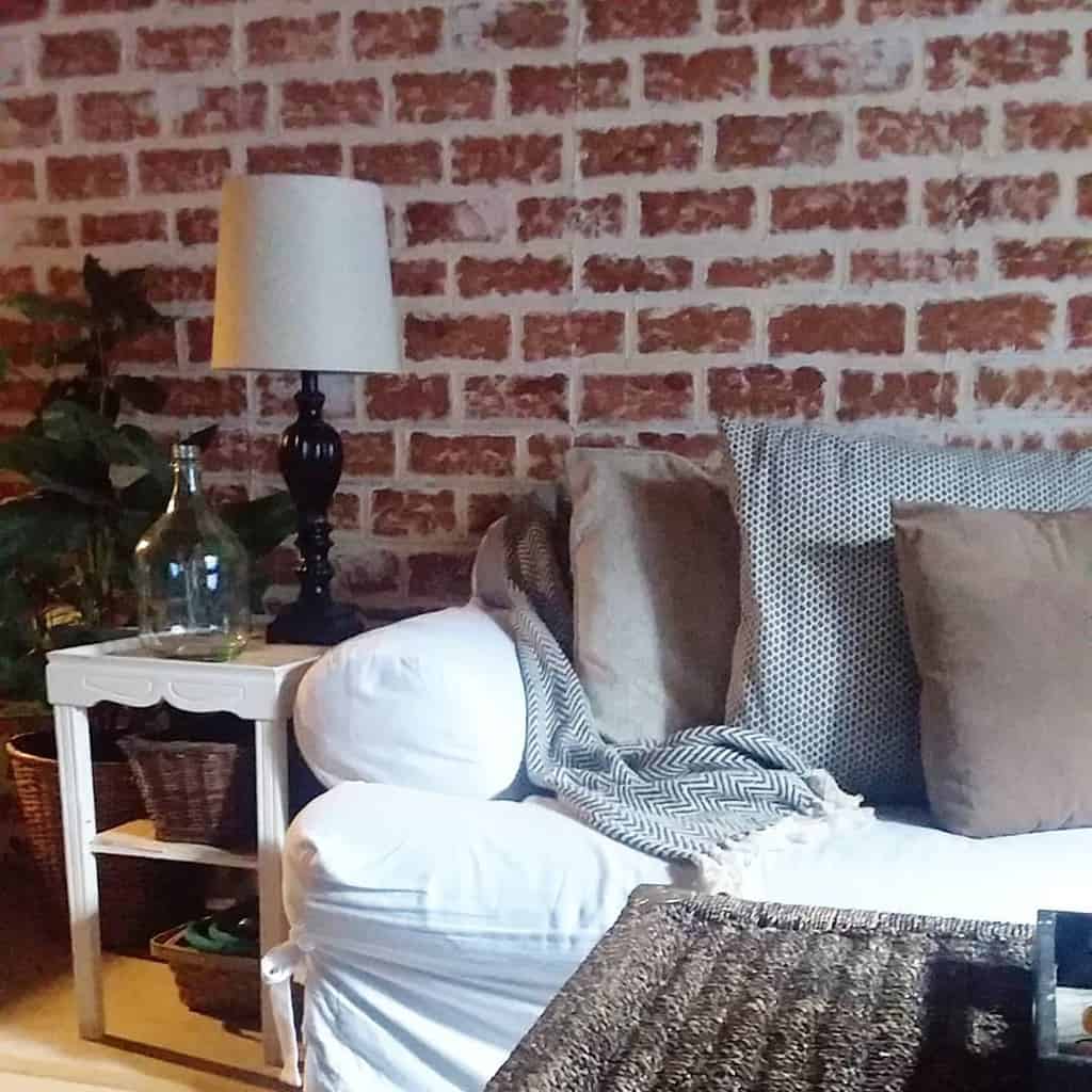 Exposed wall with white couch