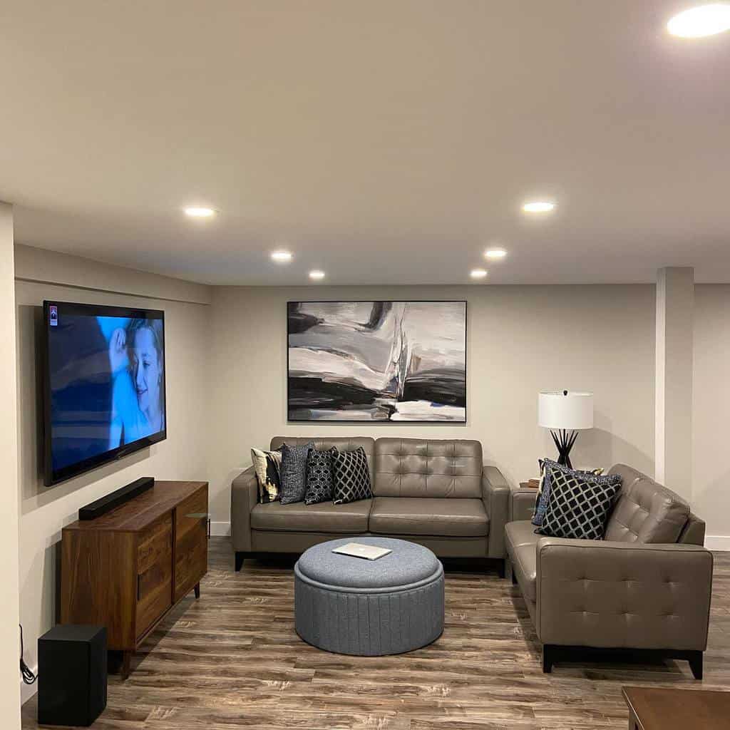 Modern basement with gray couch