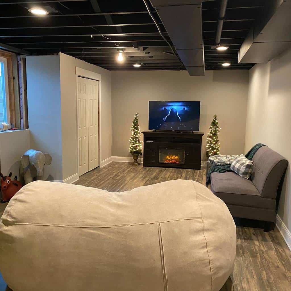Simple basement lounge with fireplace and TV