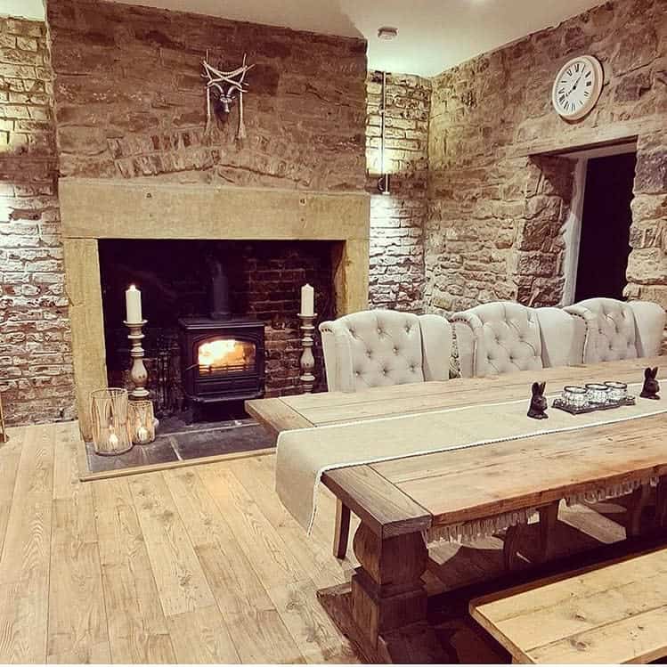 Dining room with stone wall and fireplace