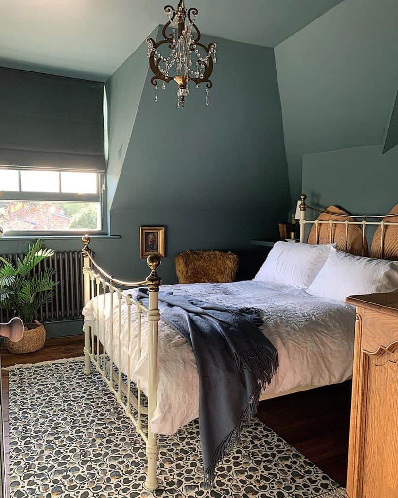 Retro attic bedroom with green wall and four-poster bed 
