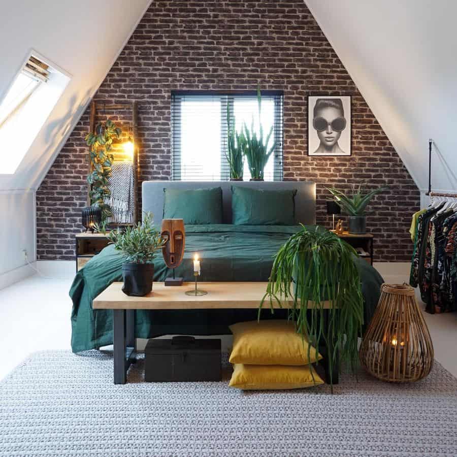 Vintage attic bedroom with brick wall and green bed