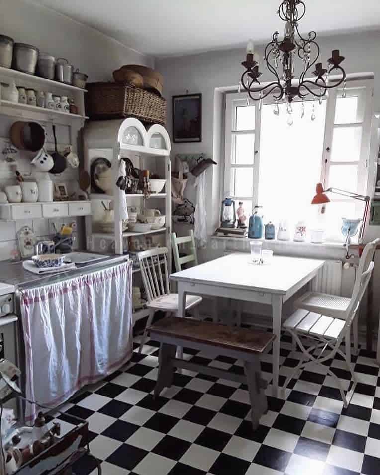 white rustic kitchen, white wooden table, black and white tile floor chandelier