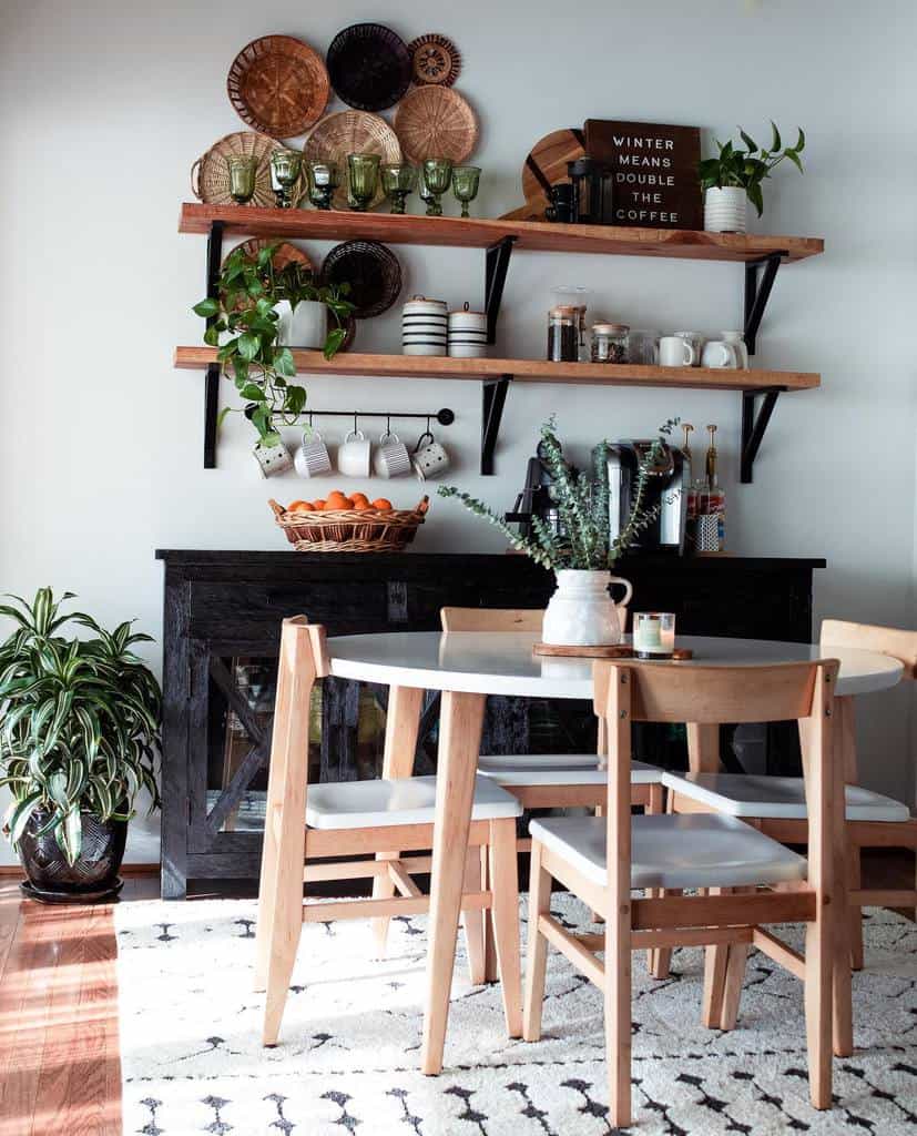 Rustic dining room table with four chairs and wall shelves 