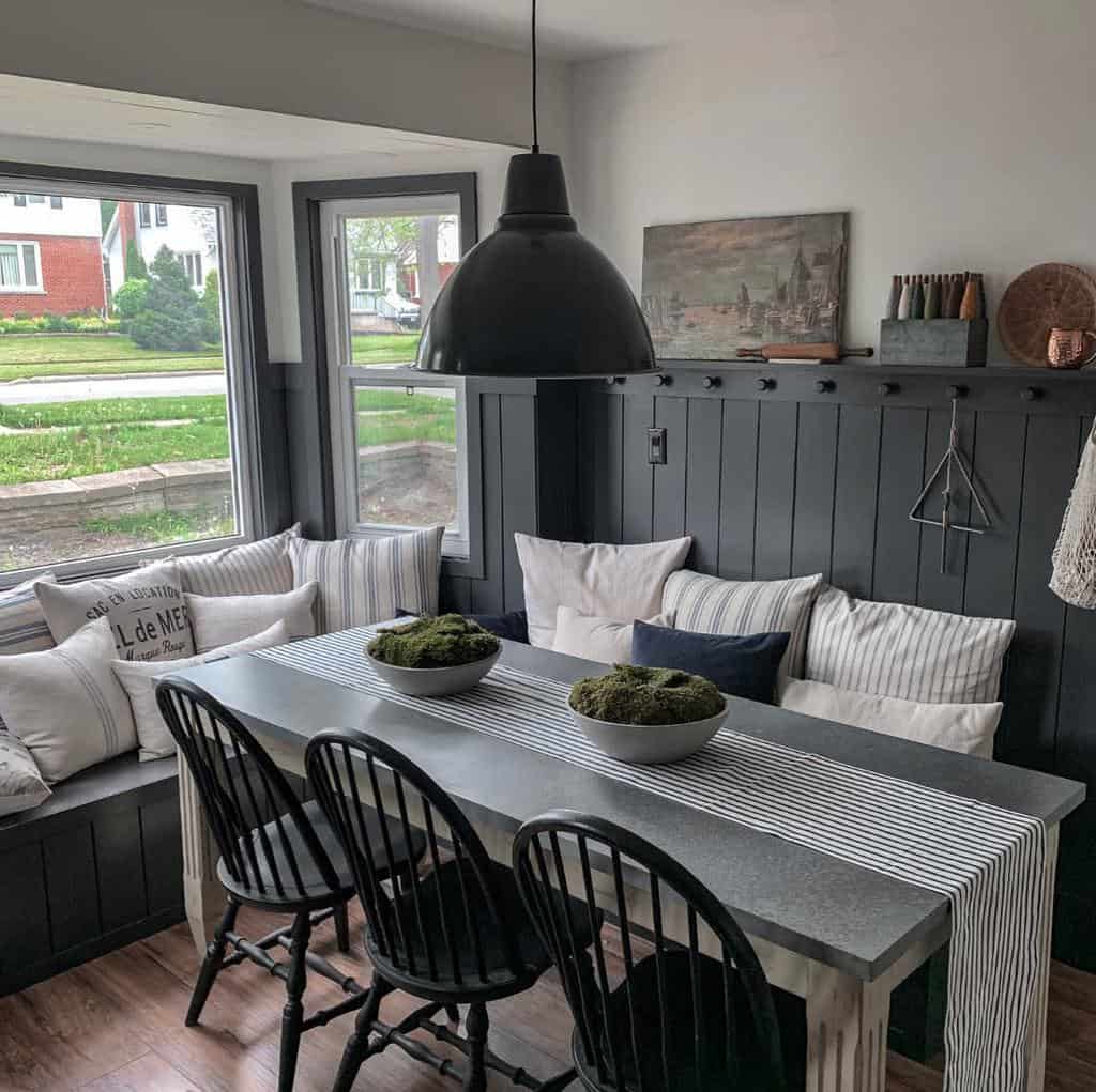 Small gray dining room with window corner, rectangular table with seating 