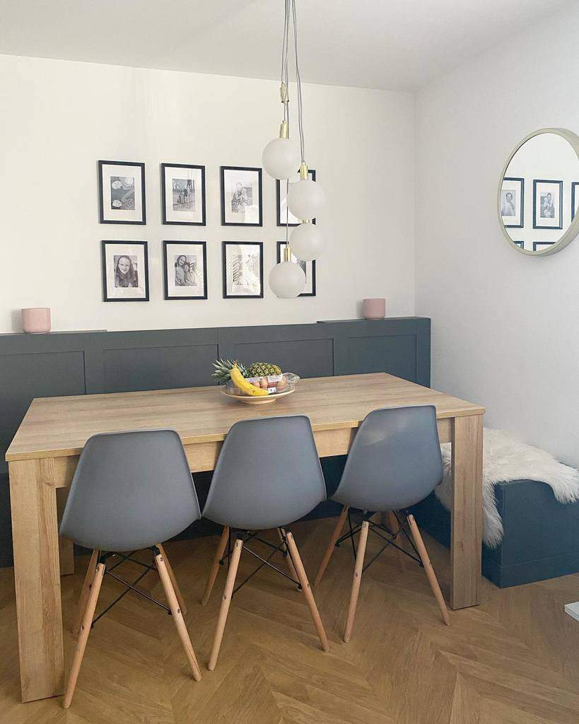small wooden dining room table, three gray chairs, photo wall art