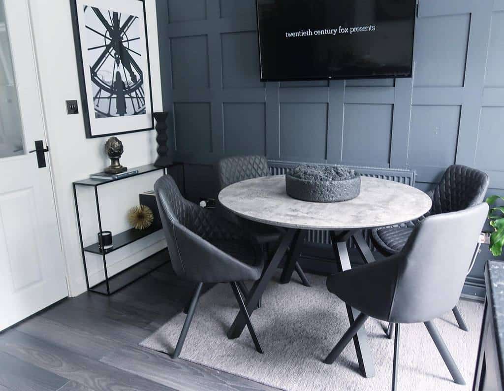 small modern dining room, round dining table, four gray chairs, wall mounted television