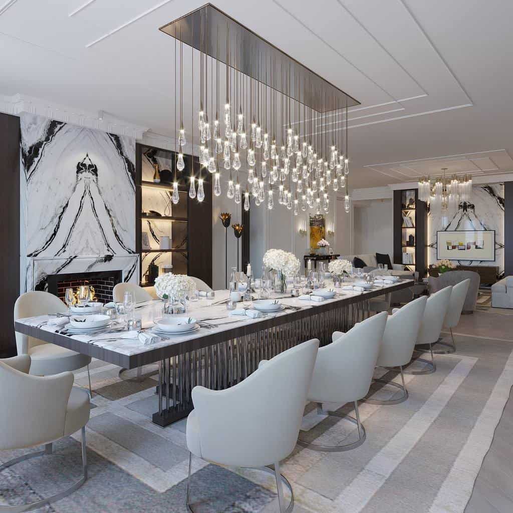 Large transitional dining room, long dining table, gray chairs, marble fireplace, chandelier