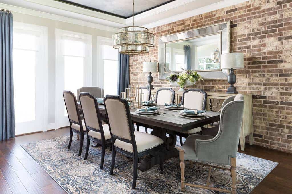 Brick accent wall, dining room, vintage table and chairs, chandelier, wall mirror