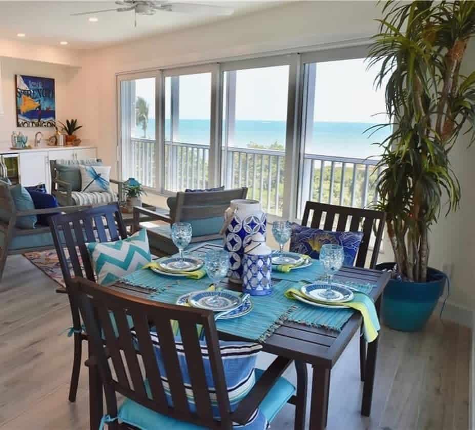 Dining table and chairs, blue themed table decoration, sea view 