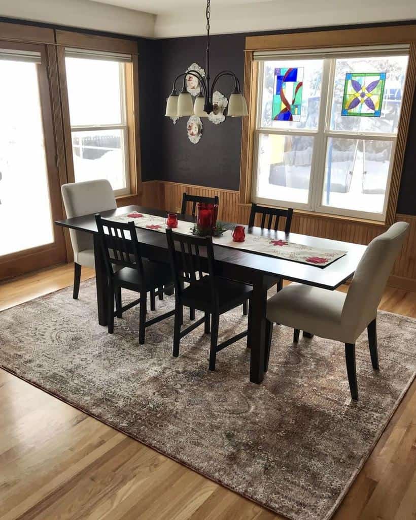 small dining room, long black dining table with two-tone wood chairs and black floor carpet on the walls 