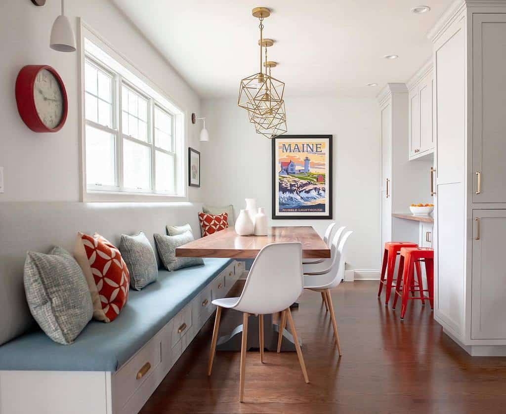 modern wooden dining room table, white chairs, bench, white kitchen cabinets, red wall clock